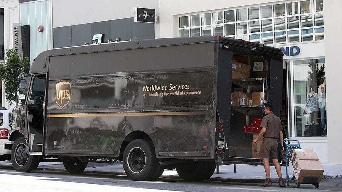 A United Parcel Service (UPS) driver loads a cart with boxes before making a delivery on June 17, 2014 in San Francisco, California.