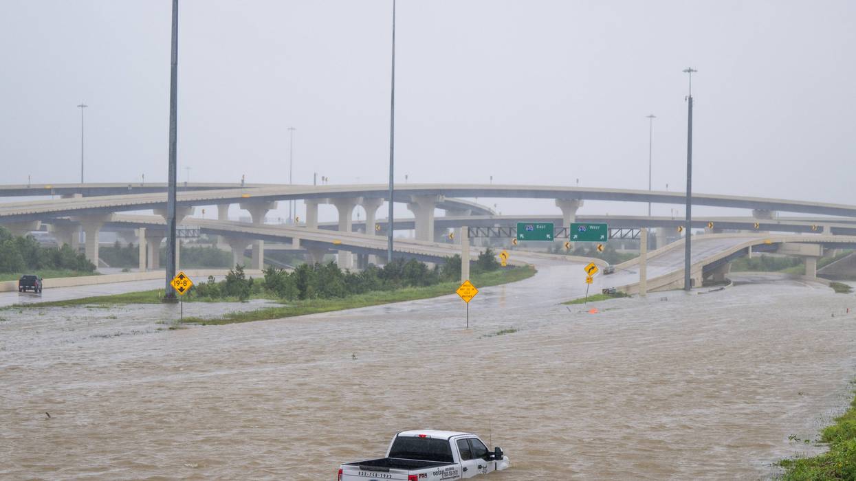 A vehicle is left abandoned in floodwater on a highway after Hurricane Beryl swept through the area on July 8, 2024, in Houston, Texas. Tropical Storm Beryl developed into a Category 1 hurricane as it hit the Texas coast late last night.