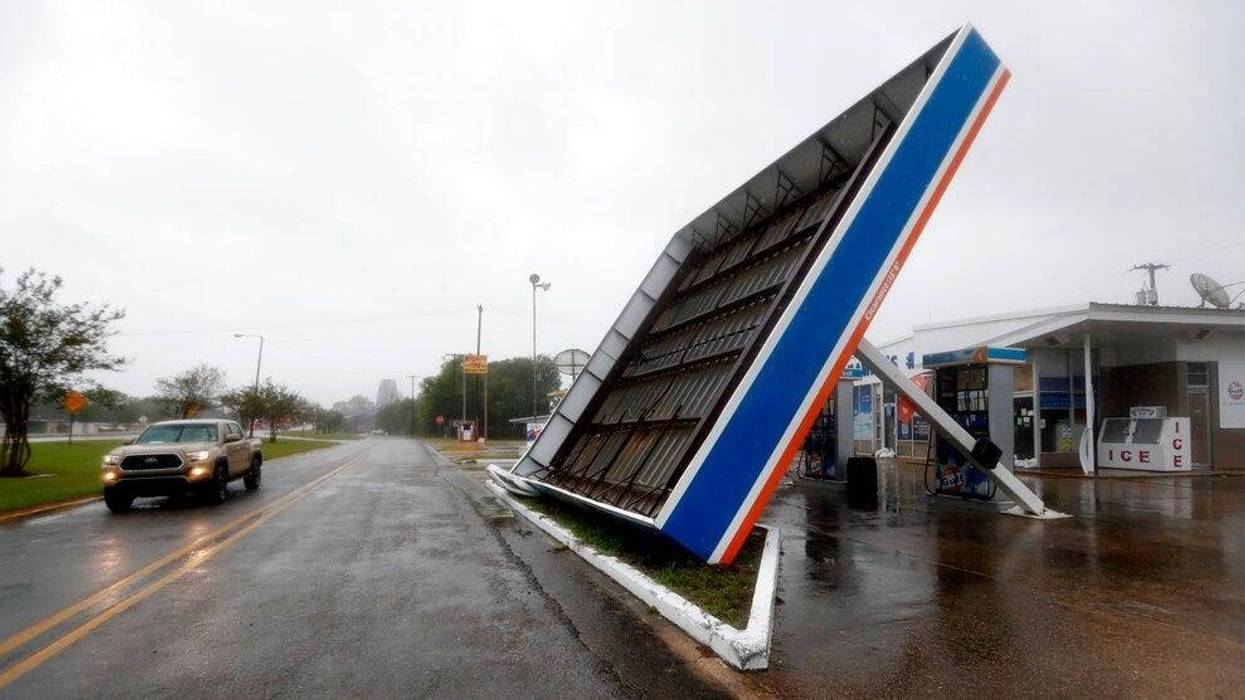 A vehicle passes a toppled gas pump canopy in Berwick, La., following a severe weather assault from Tropical Storm Barry, Saturday, July 13, 2019.