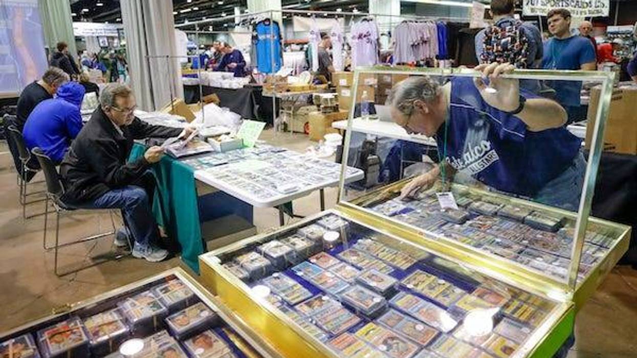 A vendor looks through baseball cards at a card show
