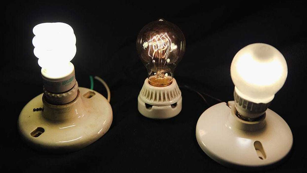 A vintage-style incandescent light bulb (C) is shown with an LED light bulb (R) and a compact florescent (CFL) light bulb on December 27, 2013 in Chicago, Illinois.