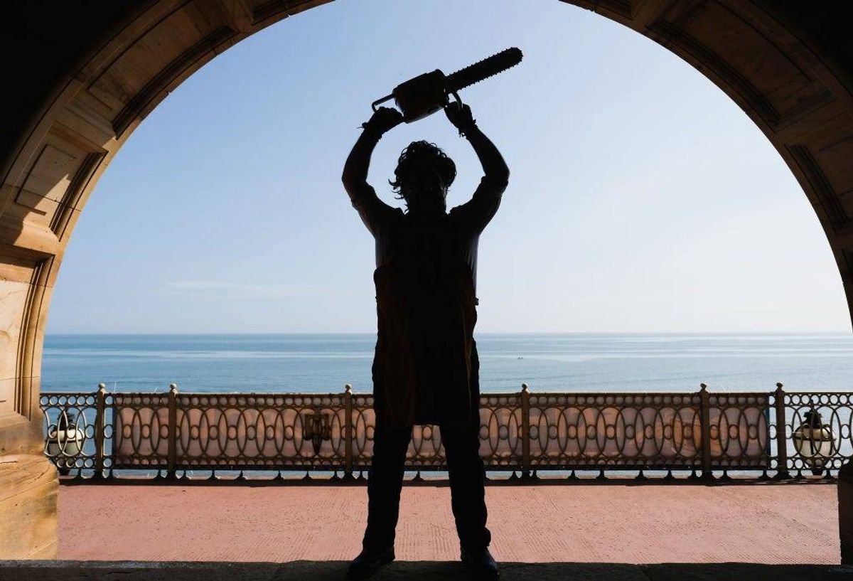 A visitor dressed as the character Leatherface from the movie Texas Chainsaw Massacre