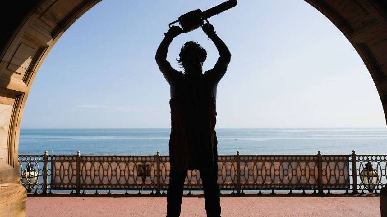 A visitor dressed as the character Leatherface from the movie Texas Chainsaw Massacre