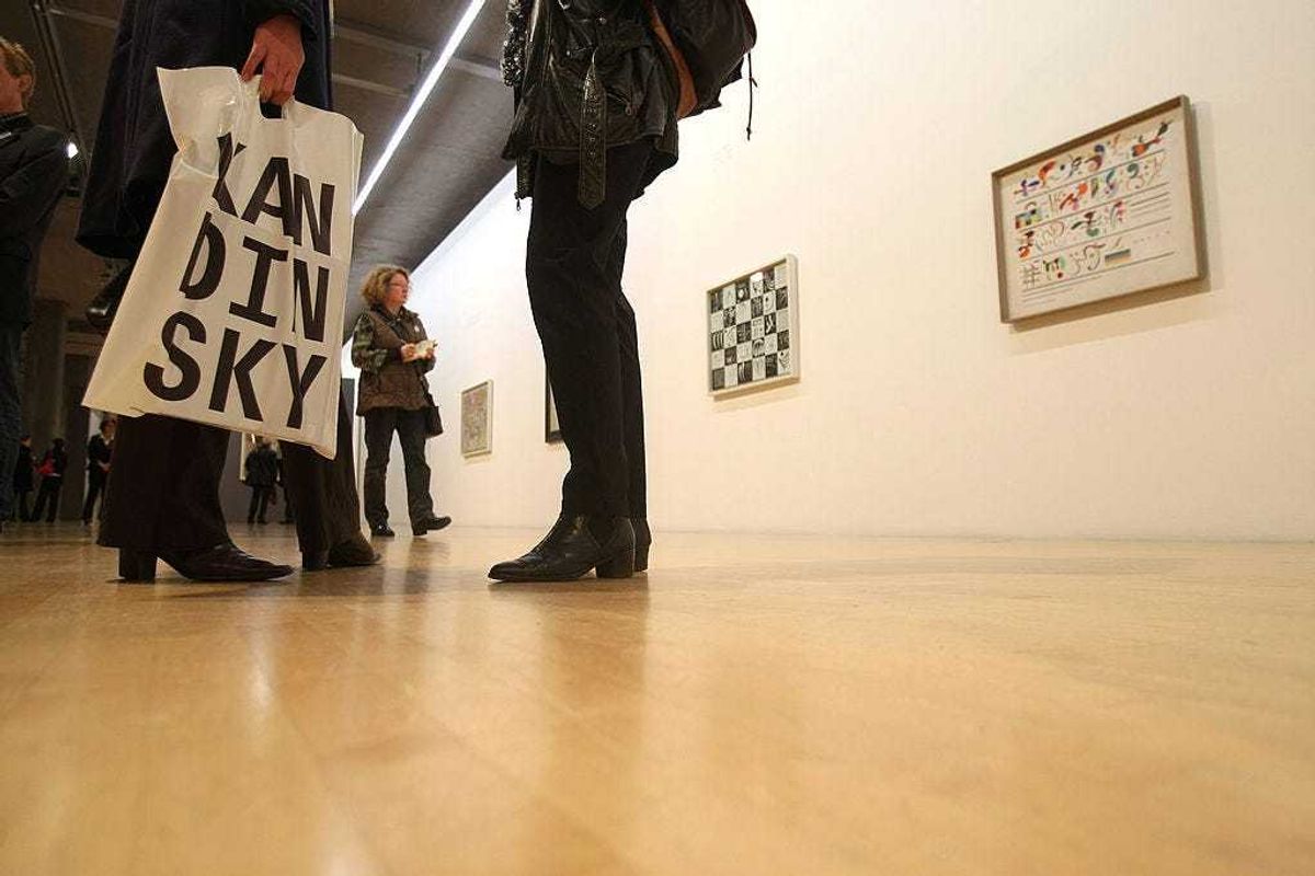 A visitor of the official presentation of the Kandinsky exhibition at the Lenbachhaus Kunstbau stands in front of paintings on October 23, 2008 in Munich, Germany. The exhibition, showing works of Wassily Kandinsky will start on October 25 and runs until February 22, 2009. (Photo by Ralph Orlowski/Getty Images)