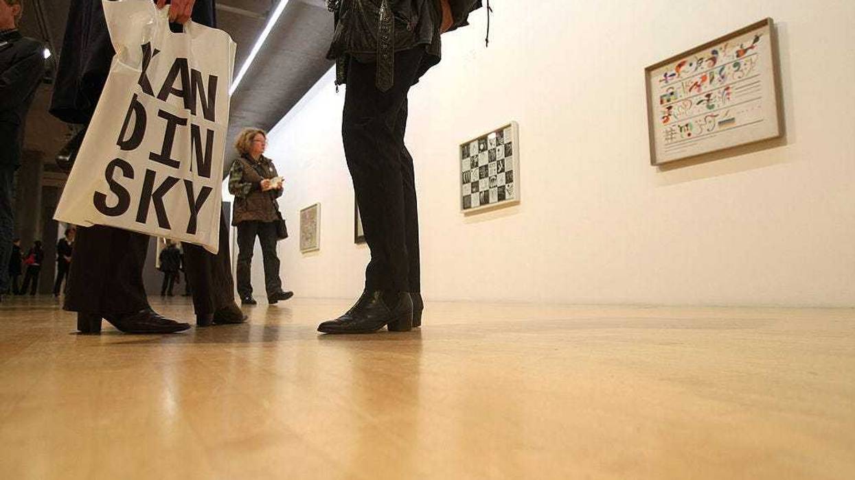 A visitor of the official presentation of the Kandinsky exhibition at the Lenbachhaus Kunstbau stands in front of paintings on October 23, 2008 in Munich, Germany. The exhibition, showing works of Wassily Kandinsky will start on October 25 and runs until February 22, 2009. (Photo by Ralph Orlowski/Getty Images)