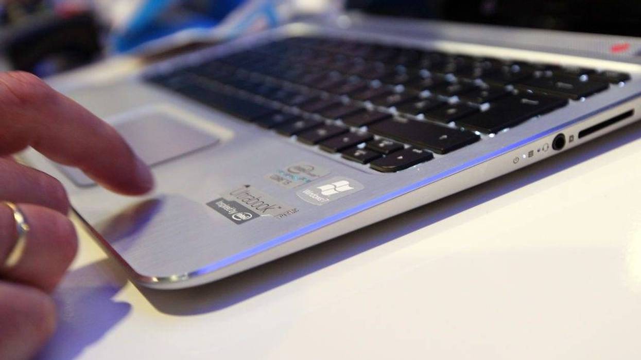A visitor tries out an HP Spectre XT laptop computer featuring an Intel Ultrabook processor at the Internationale Funkausstellung (IFA) 2012 consumer electronics trade fai