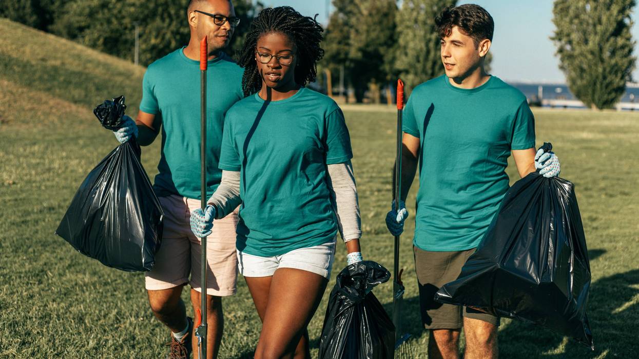 A volunteer group cleans up a park.