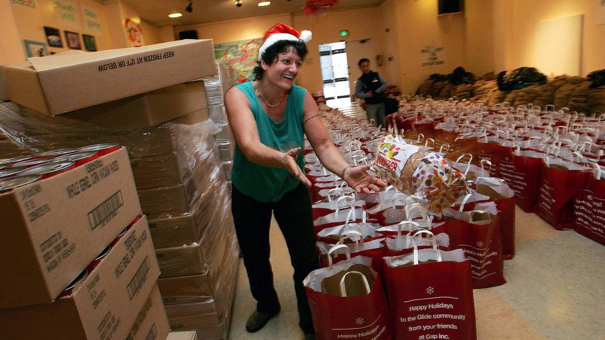 A volunteer tosses a loaf of bread that will be put into grocery bags to be distributed to the needy at Glide Memorial Church December 16, 2004 in San Francisco.