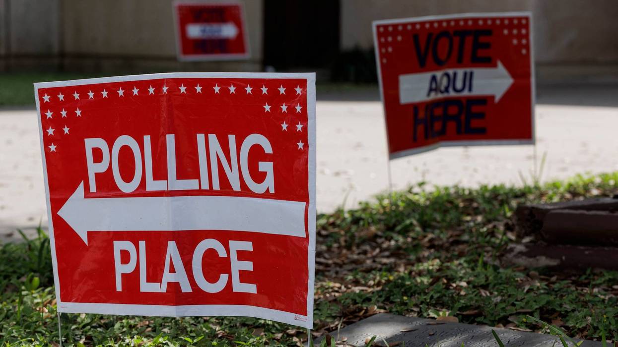 A vote here and polling location sign on outside a polling place