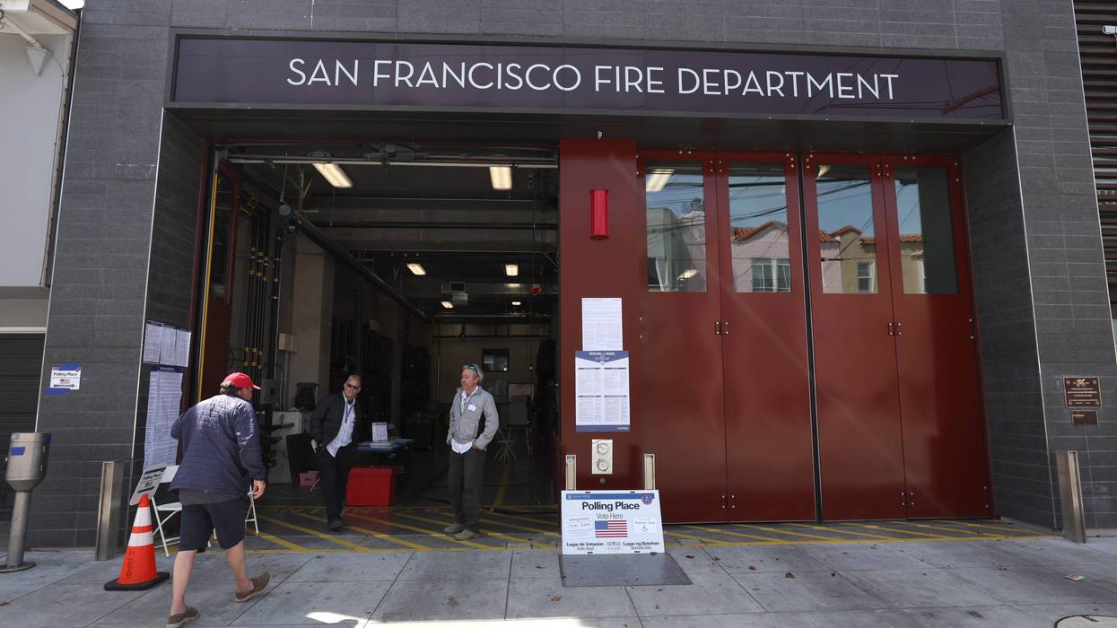 A voter is greeted by poll workers as he arrives at a polling station at San Francisco fire station 16 on June 07, 2022 in San Francisco. California.