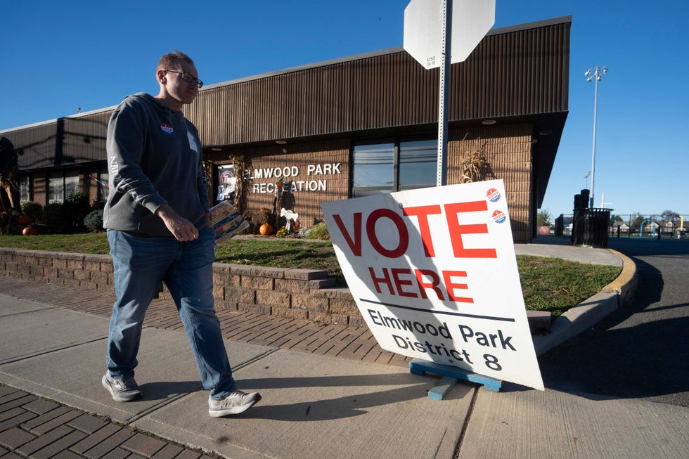 A voter walks past a voting sign at a polling location in the Elmwood Park Recreation Building on Tuesday, Nov. 4, 2025