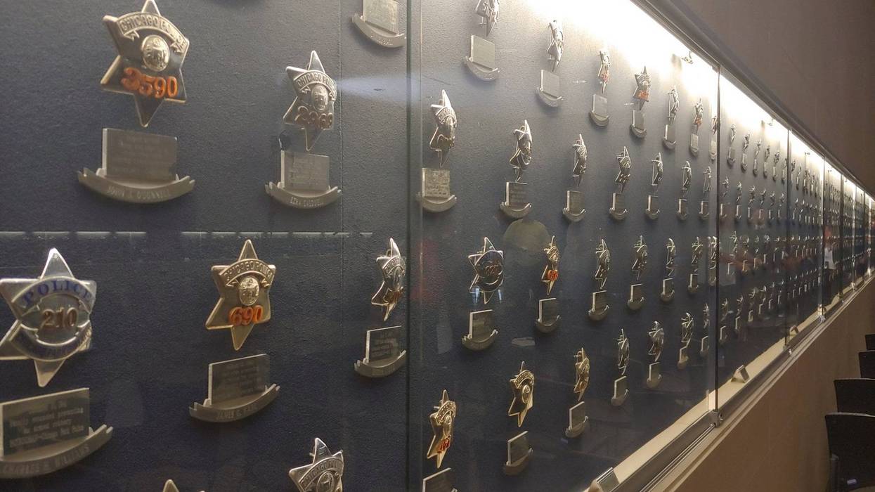 A wall of Chicago police badges enshrined behind glass
