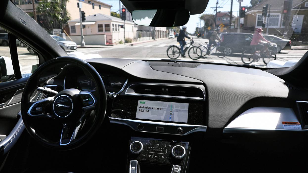 A Waymo autonomous self-driving Jaguar taxi drives along a street near Venice Beach on March 14, 2024, in Los Angeles, California.