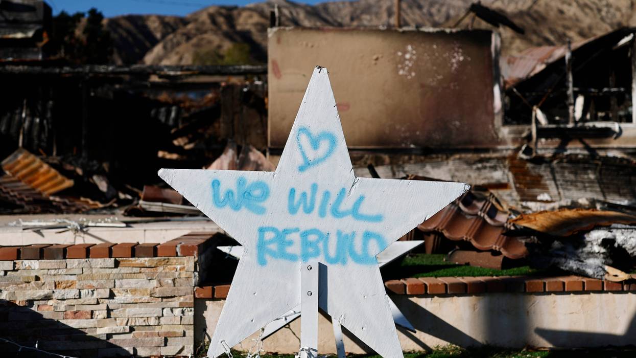 A 'We Will Rebuild' message is posted in front of a home destroyed in the Eaton Fire on March 3, 2025 in Pasadena, California.