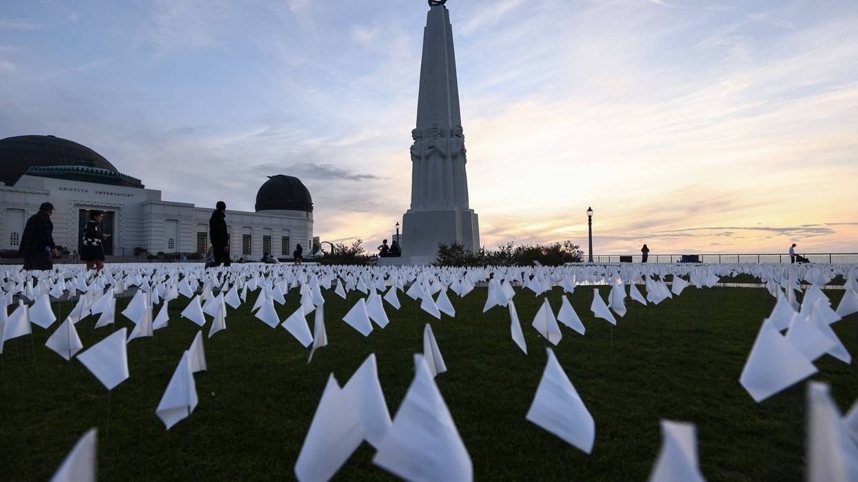 A white flag memorial installation honoring the nearly 27,000 Los Angeles County residents who have died from COVID-19 stands outside Griffith Observatory on November 18, 2021 in Los Angeles, California.