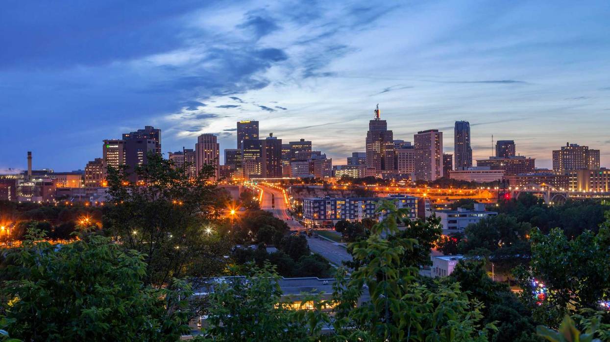A wide angle shot of the city lights of St. Paul, Minnesota coming on during a summer twilight.