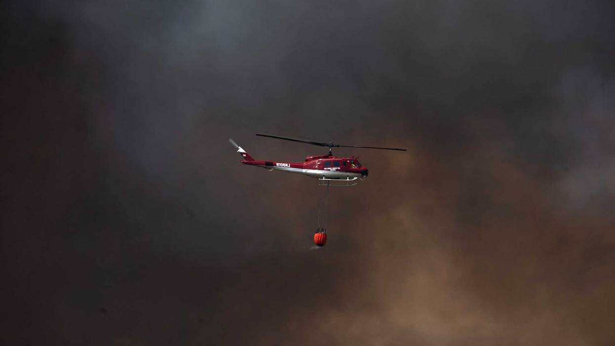 A wildfire burns in the Pinelands Forest northwest of Wells Mills Park along Route 532 near Jones Road in Ocean Township on April 22, 2025