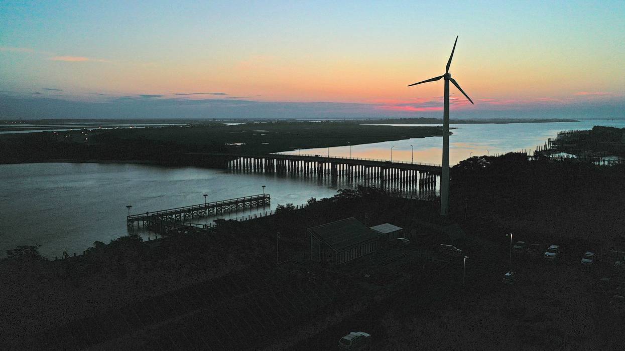 A wind turbine spins at sunrise on July 20, 2022 in Lido Beach, New York.