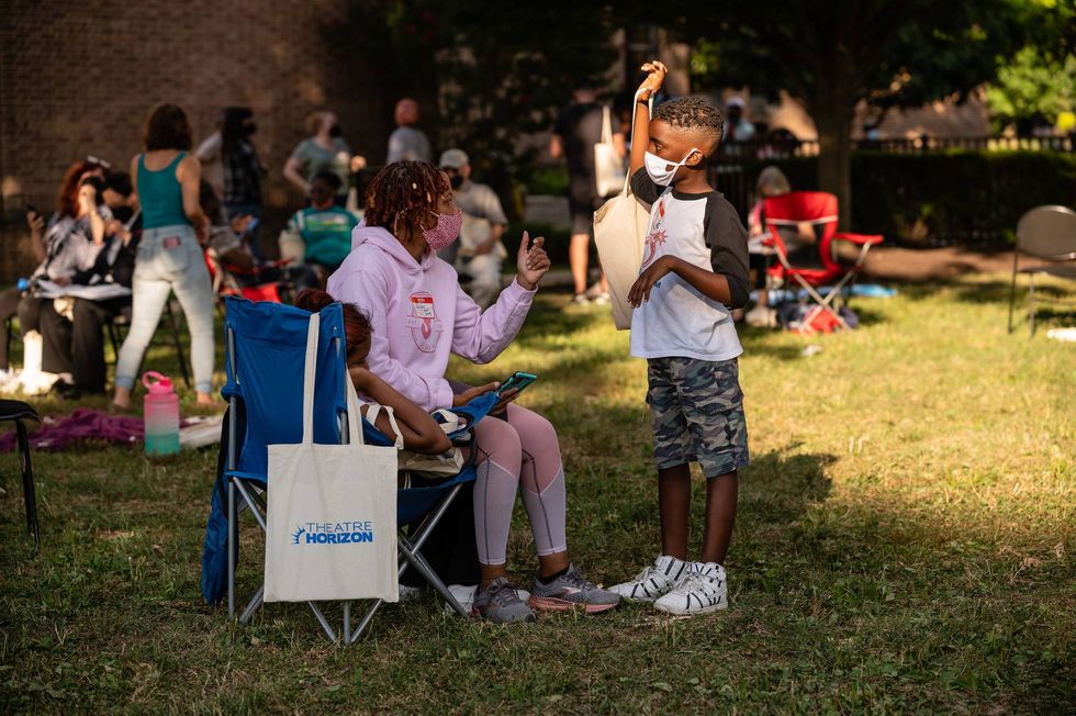 A woman and child during rehearsal for "TOWN."