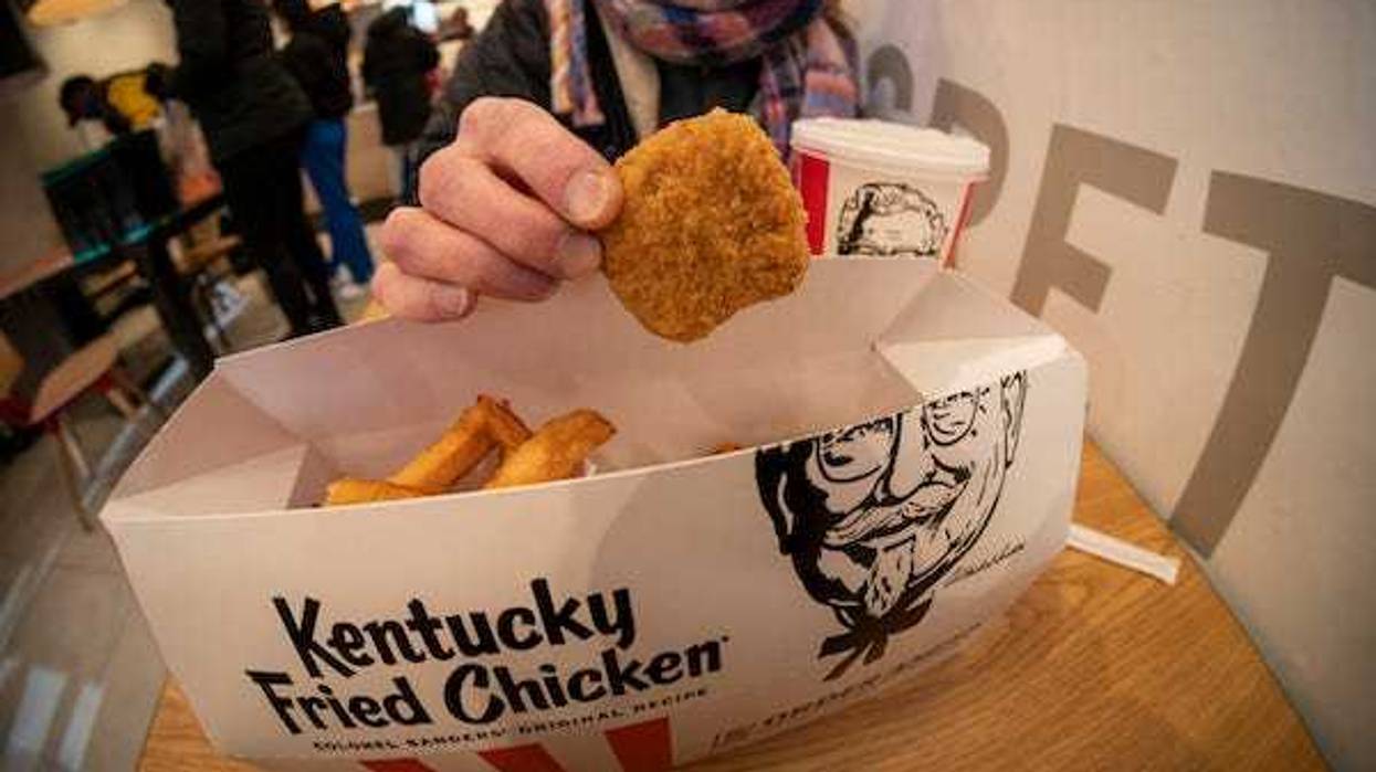 A woman enjoys a combo order of Beyond Fried Chicken at a KFC in Midtown Manhattan