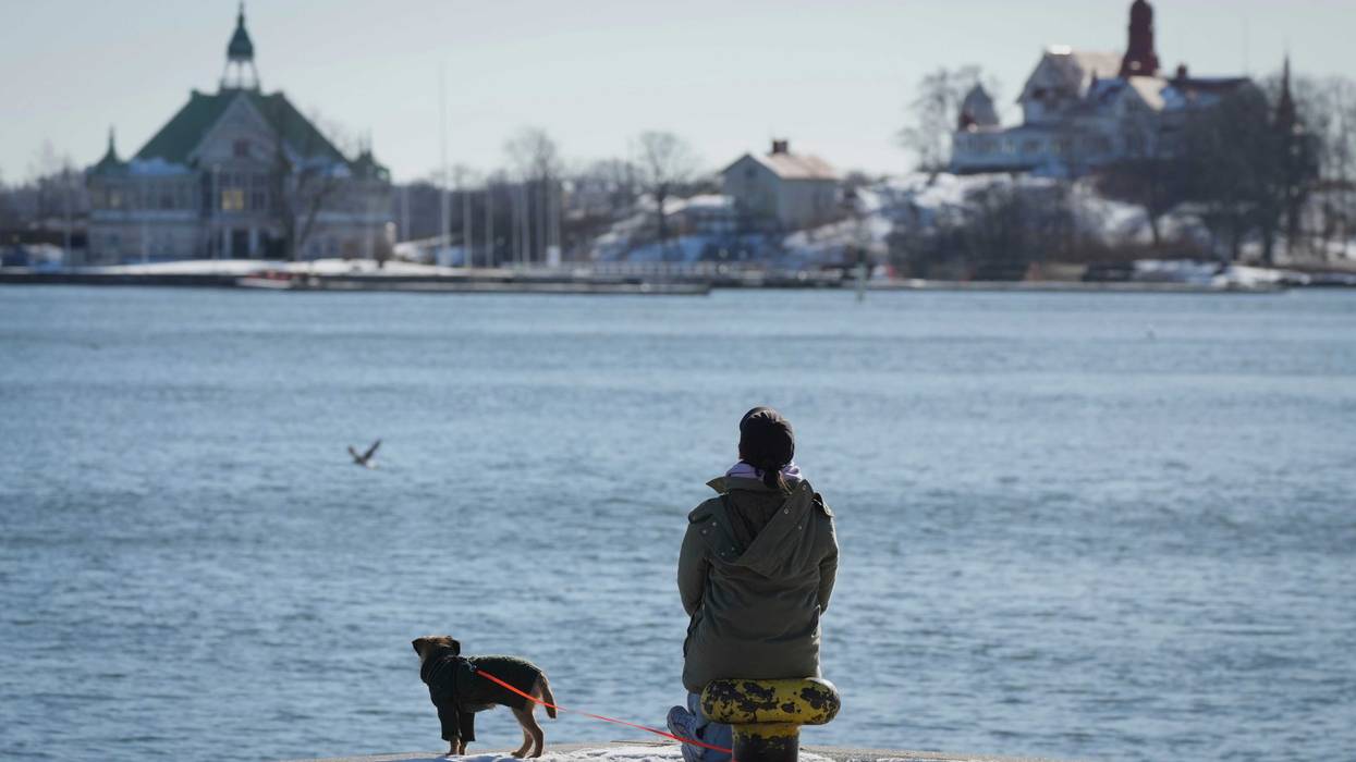 A woman enjoys a sunny and frosty day on the embankment of the South Harbour in Helsinki, Finland which is again the "happiest country in the world."