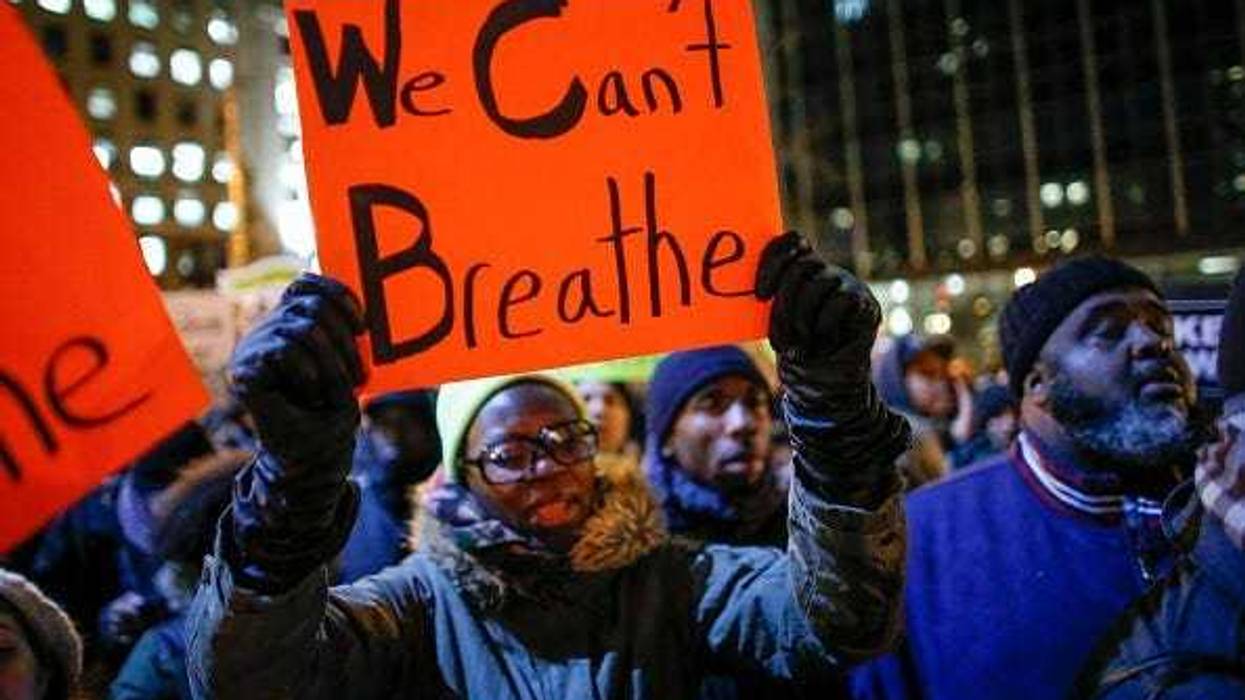 A woman holds a 'We Can't Breathe' sign at a protest following a grand jury's decision not to indict NYPD officers in the death of Eric Garner.