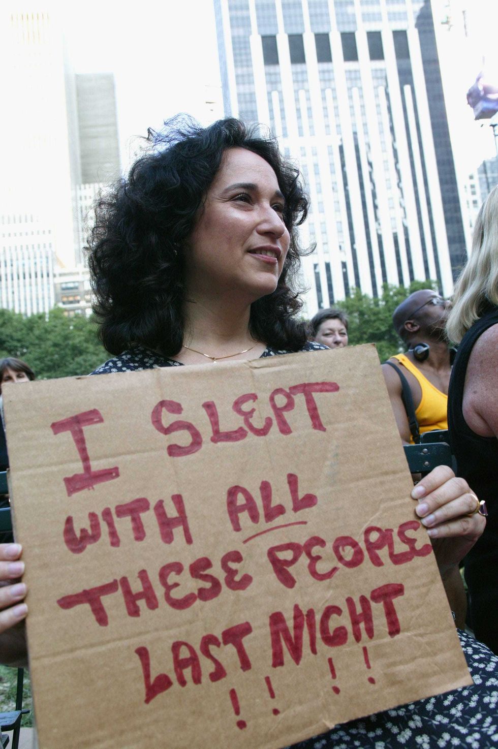 A woman holds up a sign as the Good Morning America show tapes in Bryant Park on the second day of the blackout.