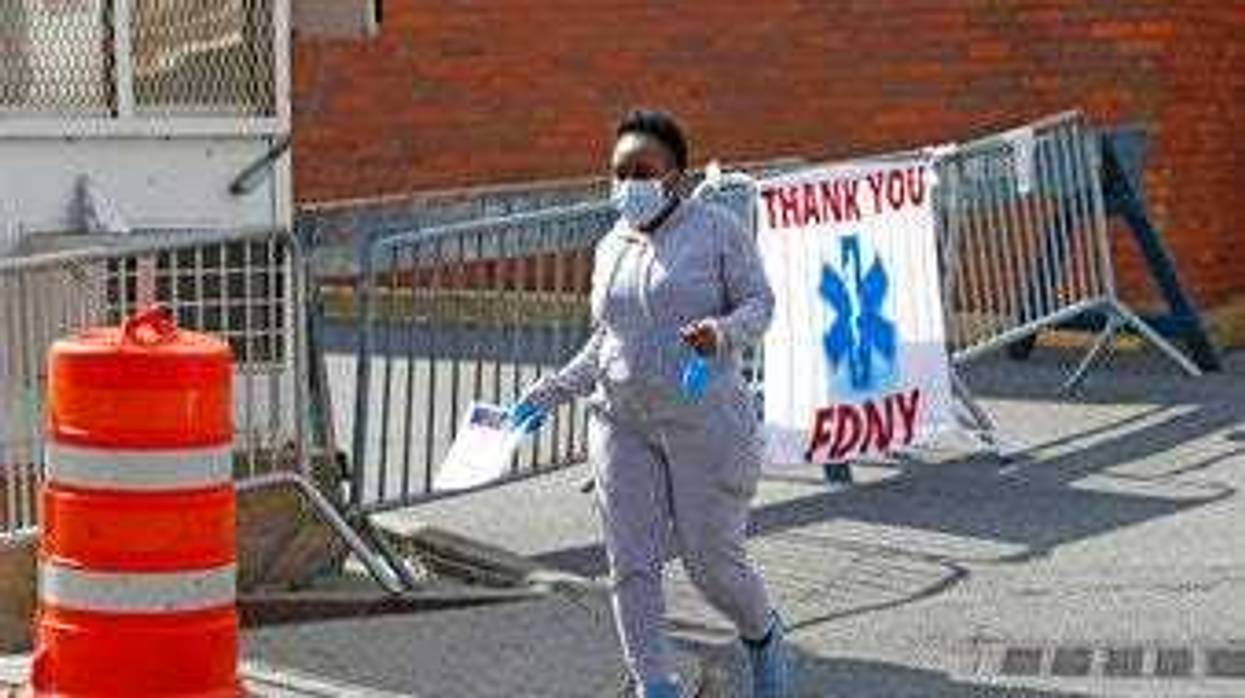 A woman leaves Elmhurst Hospital Center after being tested for COVID-19 or coronavirus during the current viral pandemic, Tuesday, April 7, 2020, in the Queens borough of New York. (AP Photo/Kathy Willens)