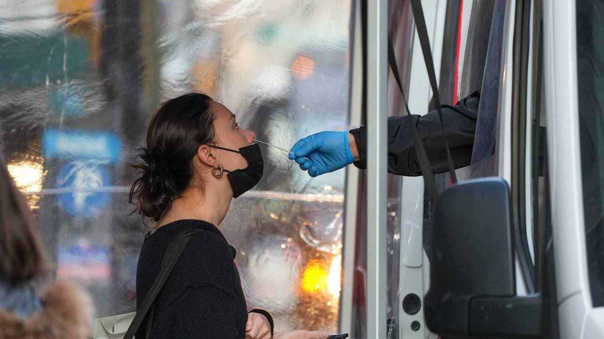 A woman receives a COVID-19 test in Manhattan on Friday
