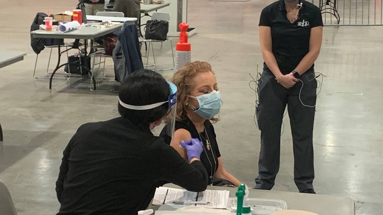 A woman receives her coronavirus vaccination
