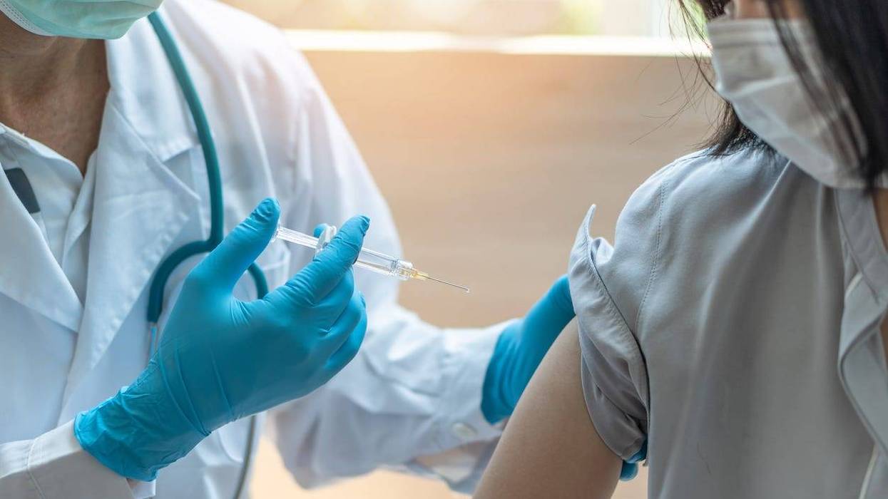 A woman receives her coronavirus vaccination