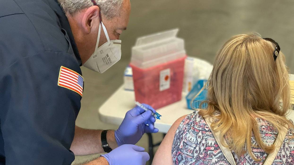 A woman receives her coronavirus vaccination