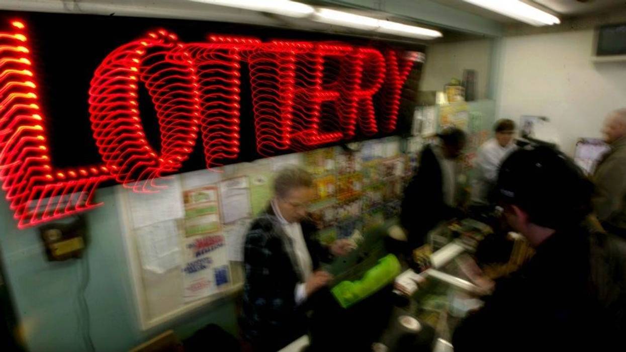 A woman sells Mega Millions lottery tickets