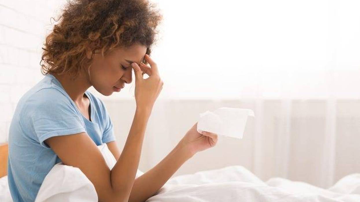 A woman sick in bed.