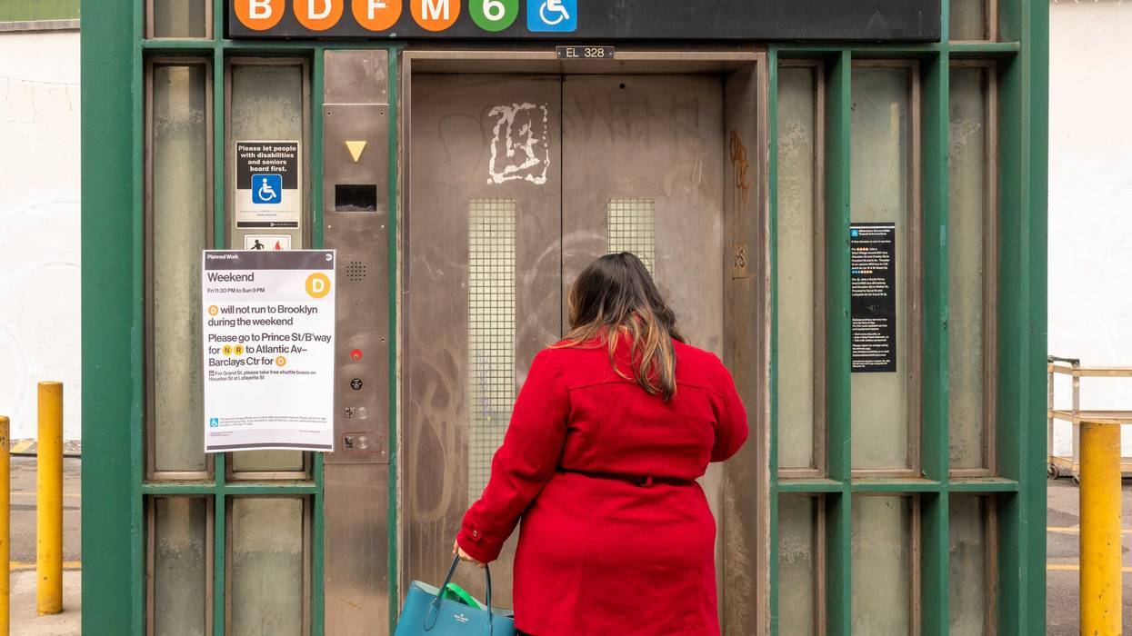 A woman waits for an elevator to take her into the subway at the Broadway–Lafayette Street/Bleecker Street station in SoHo