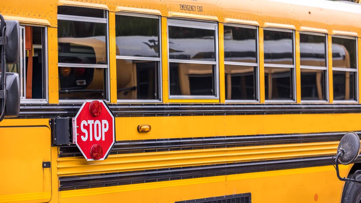 A woman was killed after a car crashed straight into a school bus in Detroit on Thursday morning, police said.