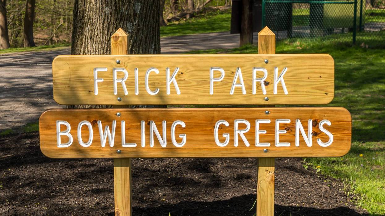 A wooden sign engraved with Frick Park Bowling Greens in Frick park located in Pittsburgh, Pennsylvania