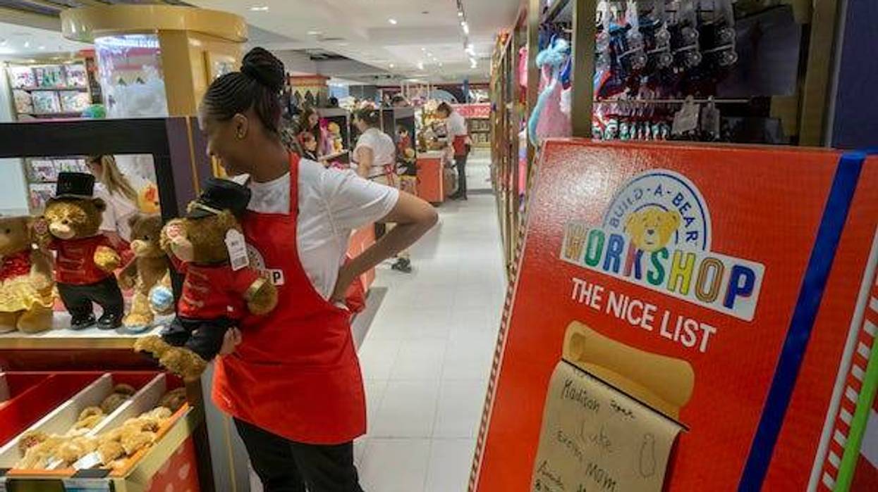 A worker in the Build-a-Bear workshop section greets customers