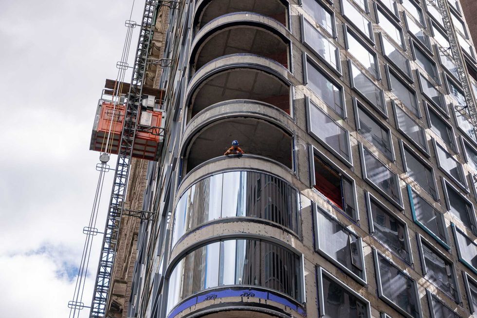 A worker peers out from a worksite in lower Manhattan moments after New York City and parts of New Jersey experienced a 4.8 magnitude earthquake on April 05, 2024 in New York City.