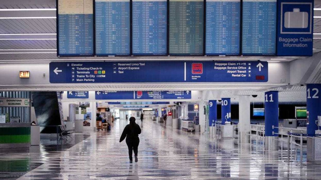 A worker walks through a baggage claim area at a nearly-empty O'Hare International Airport on April 2, 2020 in Chicago, Illinois. The airport, which typically serves 8.2 million passengers a month, has closed two of its seven runways as the COVID-19 pandemic has significantly reduced air travel. (Photo by Scott Olson/Getty Images)