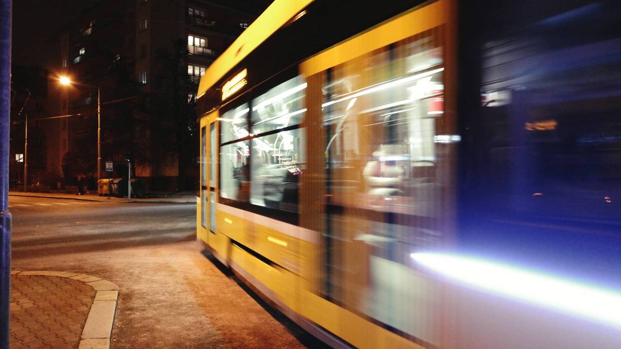 A yellow tram moves quickly