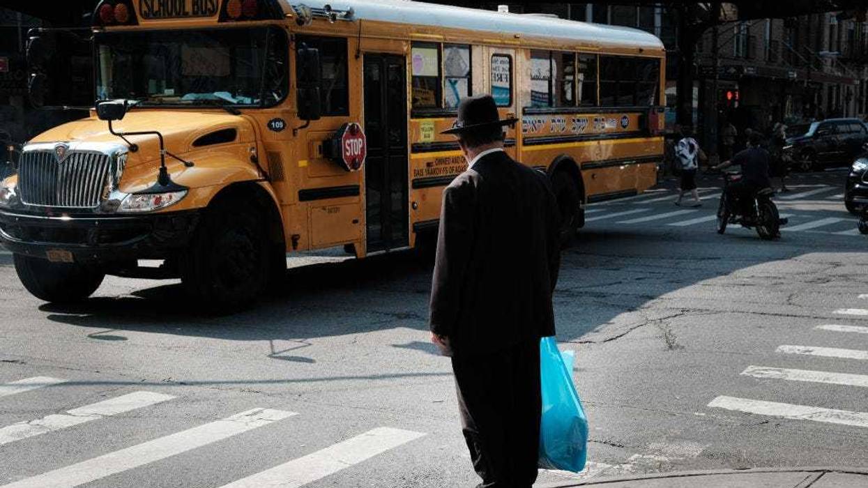 A yeshiva school bus drives through Borough Park on September 12, 2022 in the Brooklyn borough of New York City.