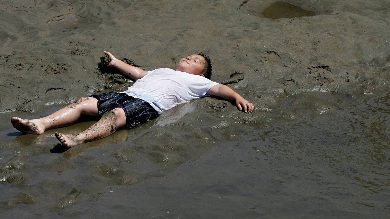 A young boy cools off in shallow water at Crissy Fields July 18, 2006 in San Francisco, California.