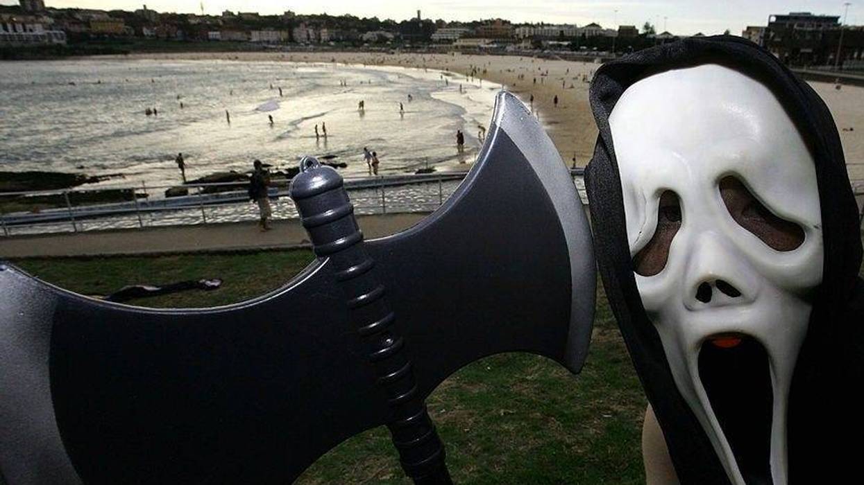 A young boy poses in a 'Scream' mask with an axe on Halloween in North Bondi on October 31, 2008 in Sydney, Australia.