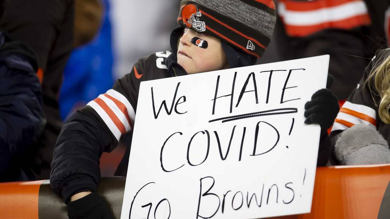 A young Cleveland Browns fan holds a sign during