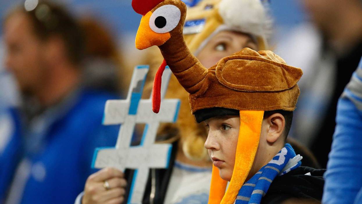 A young fan with a turkey hat looks on during the traditional Thanksgiving day game in Detroit, Michigan.