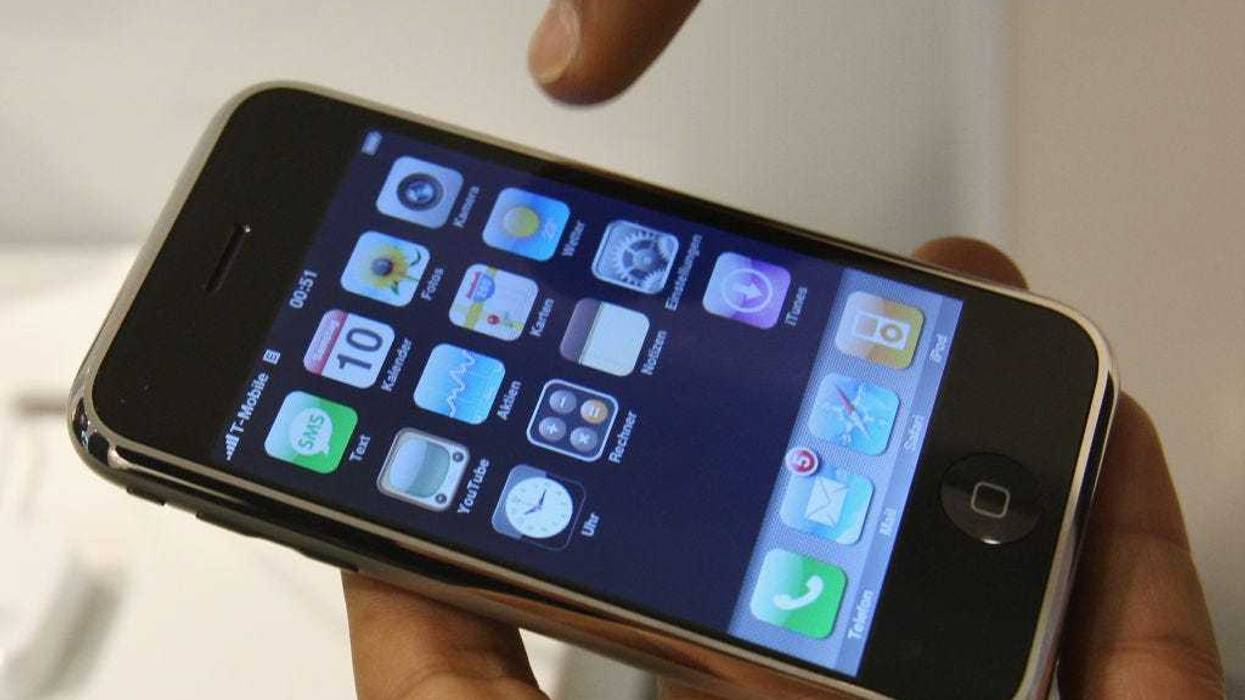 A young man checks out an Apple iPhone at a T-Mobile shop on the first day the mobile phone went on sale November 9, 2007 in Berlin, Germany.