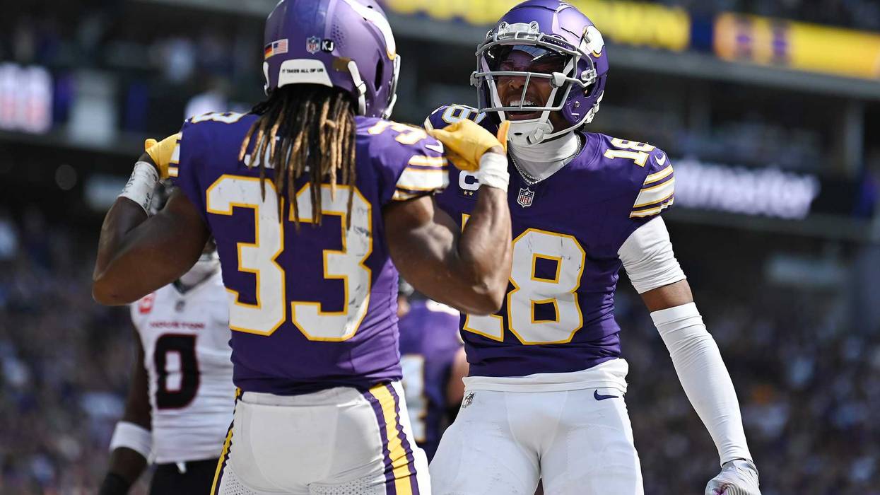 Aaron Jones #33 of the Minnesota Vikings celebrates his receiving touchdown with Justin Jefferson #18 during the first quarter against the Houston Texans at U.S. Bank Stadium on September 22, 2024 in Minneapolis, Minnesota.