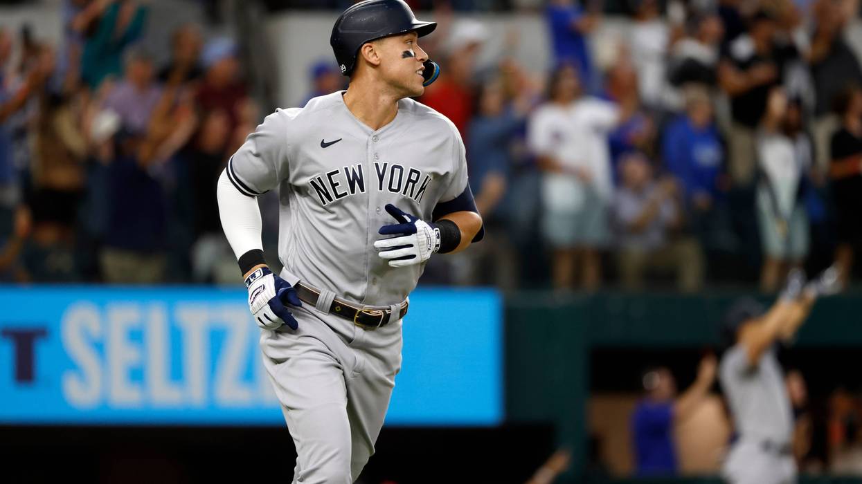 Aaron Judge #99 of the New York Yankees rounds the bases after hitting his 62nd home run of the season against the Texas Rangers during the first inning in game two of a doubleheader at Globe Life Field on Oct. 4, 2022, in Arlington, Texas. Judge has now set the American League record for home runs in a single season.