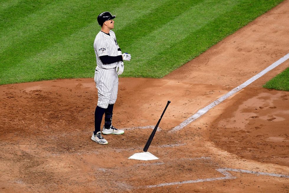 Aaron Judge drops his bat in frustration after making an out